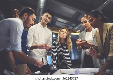 Young male and female students practicing in blueprints creation during university training lesson in office working in team with skilled leader controlling process and sharing ideas about project  - Shutterstock ID 562245727