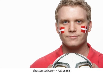 Young Male Football Fan With Danish Flag Painted On Face