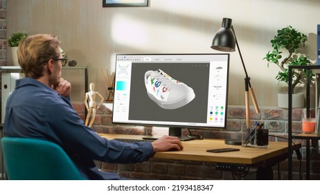 Young Male Footwear Designer Works on 3d Model of Shoe and Change Colours on It While Working on Desktop Computer in Creative Space. Shoe Production Procedure Concept.