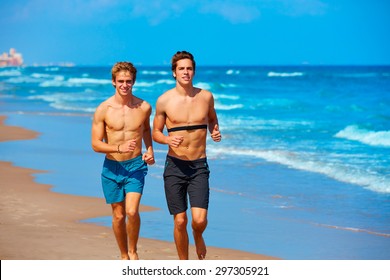 Young Male Friends Running In The Beach Shore In Summer Vacation