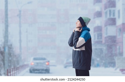 young male guy wearing warm winter season jacket on a cold day - Shutterstock ID 2124244250