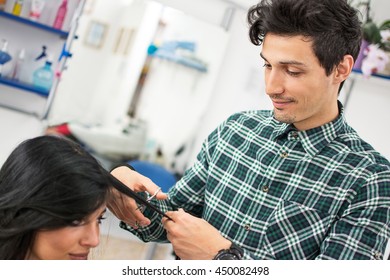 Young Male Hairdresser Cutting Hair With Scissors.