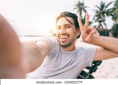 Young Male Hipster Traveler Doing Selfie Overlooking On Tropical Beach. Adventure, Vacation, Wonderlust, Internet, Technology Concept.