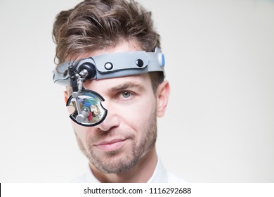 Young Male Laryngologist Doctor Wearing Head Mirror