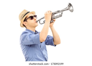 Young male musician playing trumpet isolated on white background
