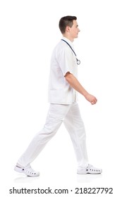 Young Male Nurse Walking, Side View. Full Length Studio Shot Isolated On White.