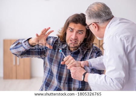Young male patient visiting experienced doctor neurologist