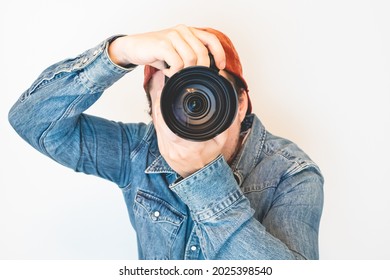 Young Male Photographer Holding  A Camera And Taking A Picture.