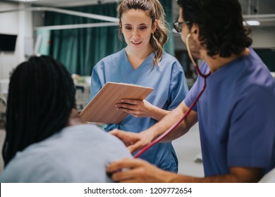 Young Male Physician Examining A Patient