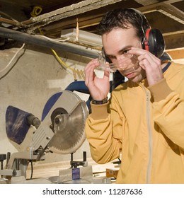 Young Male Putting On His Safety Goggles Before Using His Power Tools