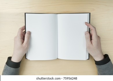 Young Male Reading An Empty Open Book On A Desk - Insert Your Own Message