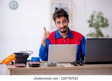 Young male repairman repairing computer - Shutterstock ID 2187787523