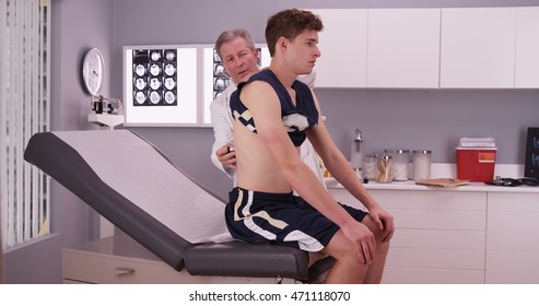 Young Male Sports Athlete Having A Doctor Checkup.