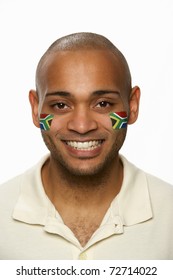 Young Male Sports Fan With South African Flag Painted On Face