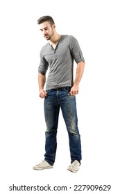 Young Male Standing Looking Down. Full Body Length Portrait Isolated Over White Background.