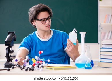 Young Male Student In The Classroom 