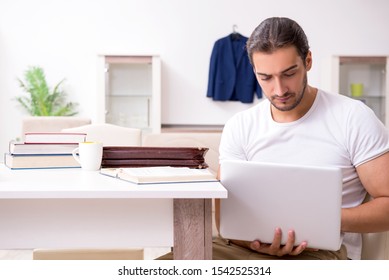Young male student preparing for exams at home - Shutterstock ID 1542525314