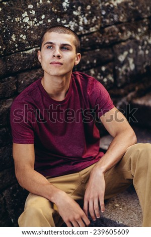 Similar – Stylish teenager sitting on a wooden bench on a city park