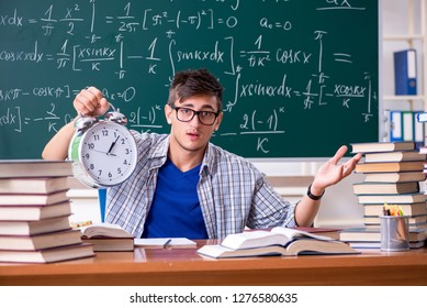 Young male student studying math at school