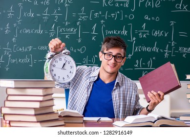 Young male student studying math at school