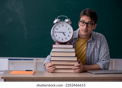 Young male student in time management concept - Powered by Shutterstock