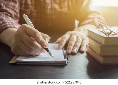 Young Male Student Writes Information From Portable Net-book While Prepare For Lectures In University Campus,hipster Man Working On Laptop Computer While Sitting In Cafe,vintage Color,selective Focus