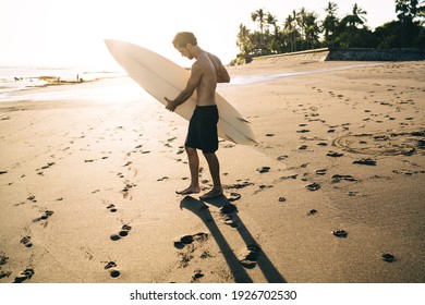 Young Male Surfer Spending Free Daytime For Practice Favourite Water Hobby Standing At Carribean Beach, Caucasian Man With Surfboard Enjoying Summer Getaway To Tropical Paradise For Recreating