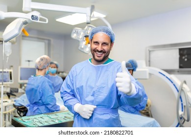 Young male surgeon standing in operating room showing thumbs up, ready to work on a patient. Male medical worker surgical uniform in operation theater. - Powered by Shutterstock