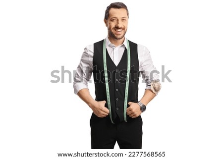 Young male tailor with a measuring tape smiling at camera isolated on white background