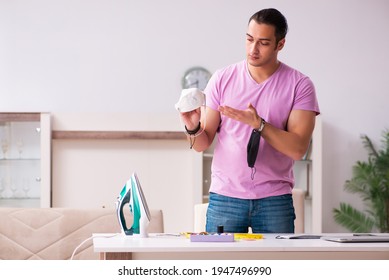 Young Male Tailor Sewing Masks At Home During Pandemic