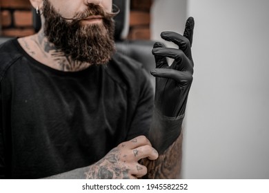 Young Male Tattoo Artist With Beard Holding Pencil And Sketch Looking Positive And Happy Standing And Smiling In Workshop Place