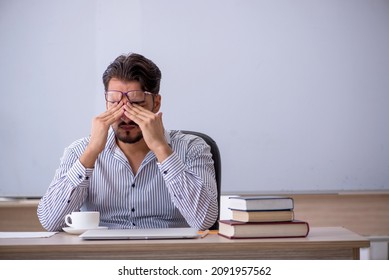 Young Male Teacher In The Classroom