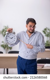 Young Male Teacher In Time Management Concept