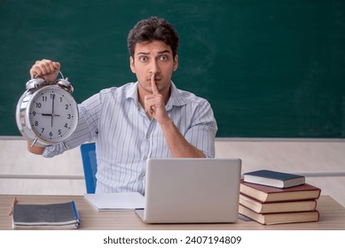 Young male teacher in time management concept - Powered by Shutterstock