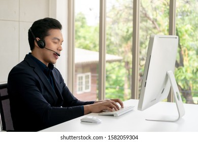 Young Male Technical Customer Support Operator Dispatcher Working with Headset in Center Office, Closeup - Shutterstock ID 1582059304