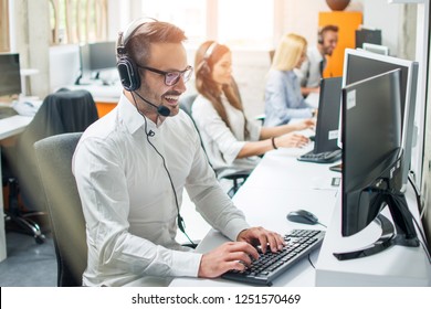 Young male technical support dispatcher in call center