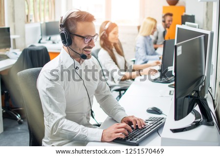 Young male technical support dispatcher in call center