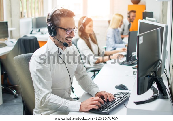 Young\
male technical support dispatcher in call\
center