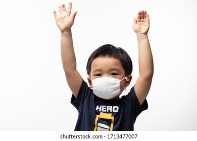 Young Male Toddler Standing Over Isolated White Background Wearing Face Mask With Both Hands Up