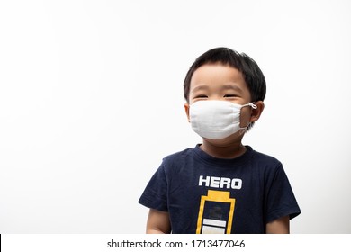 Young Male Toddler Standing Over Isolated White Background Wearing Face Mask In Neutral Position Smiling Behind The Mask Happy Expression