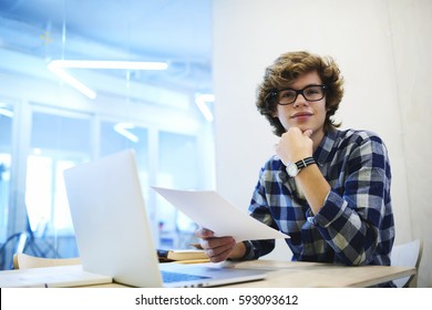 Young Male Trainee Of Business Corporation Reading Rules And Duties Of Employee Before Filling Application To Get Work Occupation Via Laptop Computer And Installed Database Of Candidates In Office