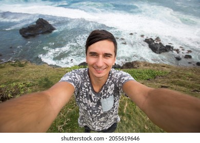 Young Male Traveler Doing Selfie Overlooking The Tropical Ocean. Adventure, Vacation, Wonderlust, Internet, Technology Concept.