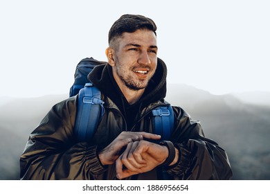 Young male traveler looking at his smart watch - Powered by Shutterstock