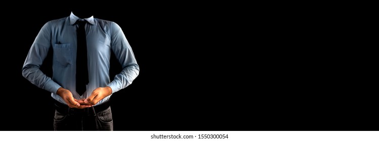 A Young Male Worker Dressed In A Blue Shirt And Black Necktie With His Hands Holding Something Against Black Background Isolated.