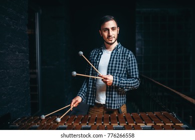 Young Male Xylophone Player With Sticks In Hands