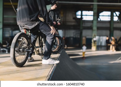 Young males staying with their bikes on the ramp. Unrecognizable BMX riders is performing tricks in indoor skatepark. BMX freestyle. Extreme sport. - Powered by Shutterstock