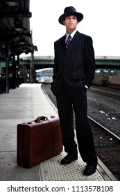 A Young Man In 1940s Style Clothes Waiting For A Train On A Train Platform