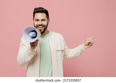 Young man 20s in trendy jacket shirt hold scream in megaphone announces discounts sale Hurry up point finger aside on workspace isolated on plain pastel light pink background. People lifestyle concept - Powered by Shutterstock