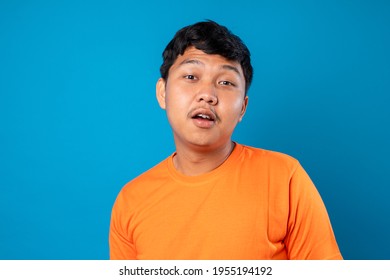 Young Man Acting Silly On Blue Background