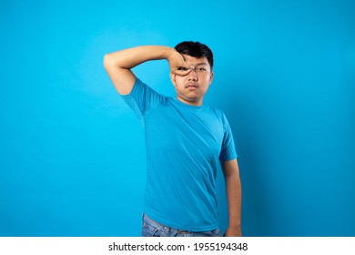 Young Man Acting Silly On Blue Background